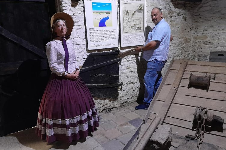 Historic barge tiller displayed at Morwellham Quay by Martyn Langsford of South West Water and Tessa Wannell of the quay