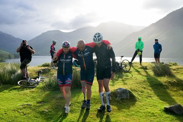20220728      Copyright image 2022Â©
Sally Orange, physiotherapist and Ben Harrop assist Lee Spencer after he is forced to stop after the wounds on his stump become too deep to enable him to push the pedals after a successful summit of Scafell Pike, Englandâs highest mountain the day before, on his Landâs End to John OâGroats part of his Triathlon of Great Britain today, 28th July 2022. He will be climbing the UKâs three highest peaks - Snowdon, Scafell Pike and Ben Nevis during the ride. Descending from Ben Nevis, Lee will then complete 26 miles before finishing at Spean Bridge. This will be completed within a 14 day period.
Lee Spencer BEM, a veteran amputee who believes that no-one should be defined by their disability, is about to take on another âfirst of a kindâ challenge - the Triathlon of Great Britain. 
To support Lee, please donate at his just giving page - https://www.justgiving.com/fundraising/thetriathlonofgb
Further information is available from Laura Milward on 00350 54003968 / laura@greenroomadvisory.comâ¨Lee is available for interviews (DTBC)
For photographic enquiries please call Anthony Upton 07973 830 517 or email info@anthonyupton.com 
This image is copyright Anthony Upton 2022Â©.
This image has been supplied by Anthony Upton and must be credited Anthony Upton. The author is asserting his full Moral rights in relation to the publication of this image. All rights reserved. Rights for onward transmission of any image or file is not granted or implied. Changing or deleting Copyright information is illegal as specified in the Copyright, Design and Patents Act 1988. If you are in any way unsure of your right to publish this image please contact +447973 830 517 or email: info@anthonyupton.com20220728      Copyright image 2022Â©
 
Apogeeâs support walkers pose during Lee Spencer at the summit of Snowdon ascending, via the Pyg Track and the descent via the Miners Tracker during the Landâs End to John OâGroats part of his Triathlon of 
