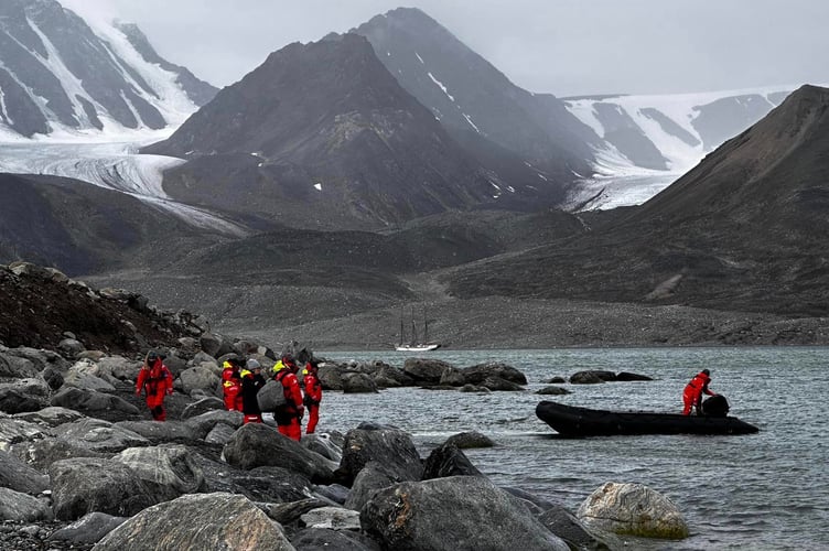 Ocean Warrior vessel SV Linden in the background as scientists test equipment in fjord