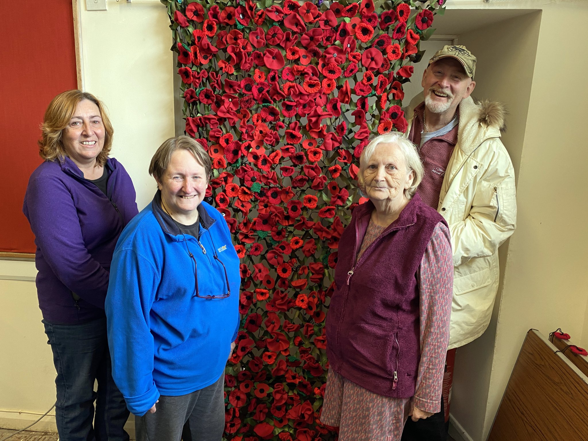 Children and villagers unite to remember with poppy creations