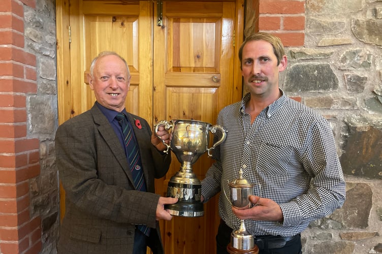 Association president Raymond Govier, left, presenting Donald Tonkin with his Devon Champion trophy. AQ 9906