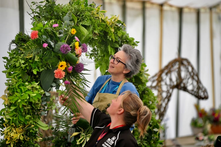 Devon County Show. Final tweaks to displays in the Crafts and Horticulture marquee