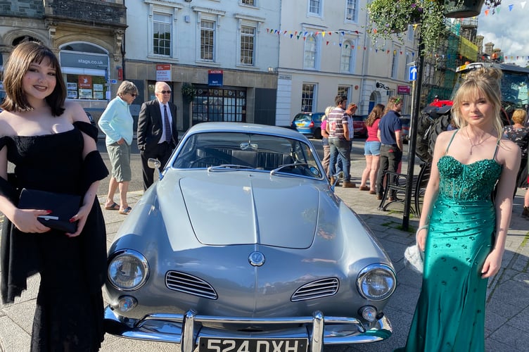 Left Harriet Sutton and friend Sophia Ellis with classic car before their proms. 