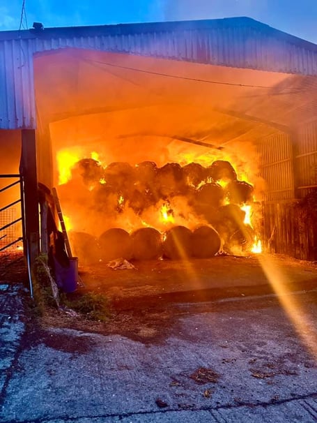 Lawhitton hay well alight in farm barn before firefighters attended