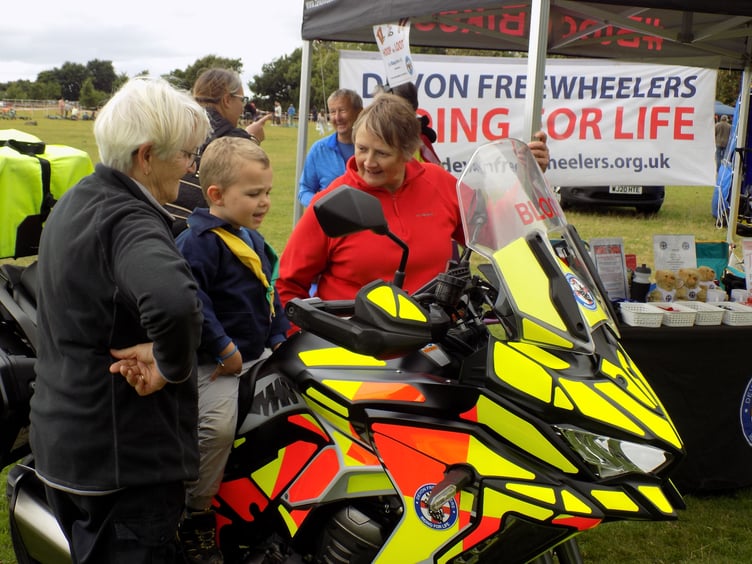Not too young to ask questions - learning all about blood bikes at Yelverton Rotary's Crafts and Fun Day