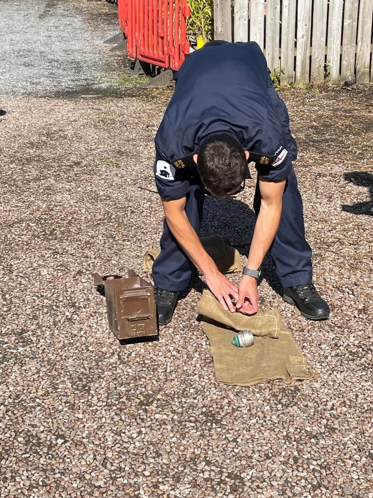 Royal Navy bomb disposal expert with the WW1 shell detonator fuses. Photo Ann Thorp