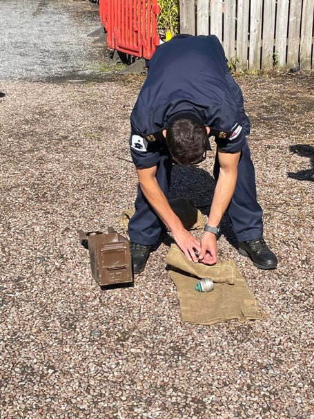 Royal Navy bomb disposal expert with the WW1 shell detonator fuses. Photo Ann Thorp 