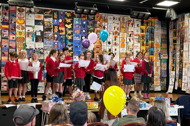 Callington Primary School singers, with their artwork in the background