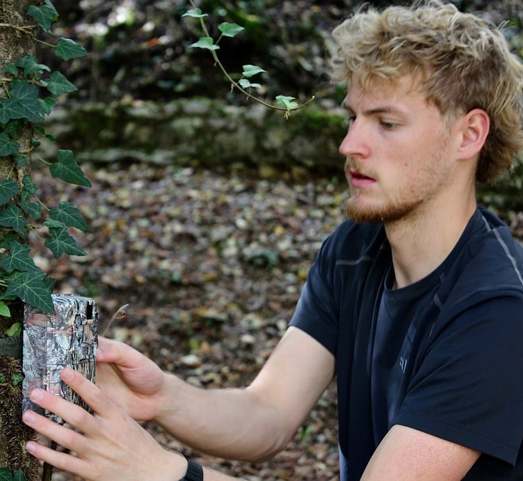 Rui Machin setting up the remote camera trap to monitor wildlife – he first used these to watch foxes with his father in the Tamar Valley