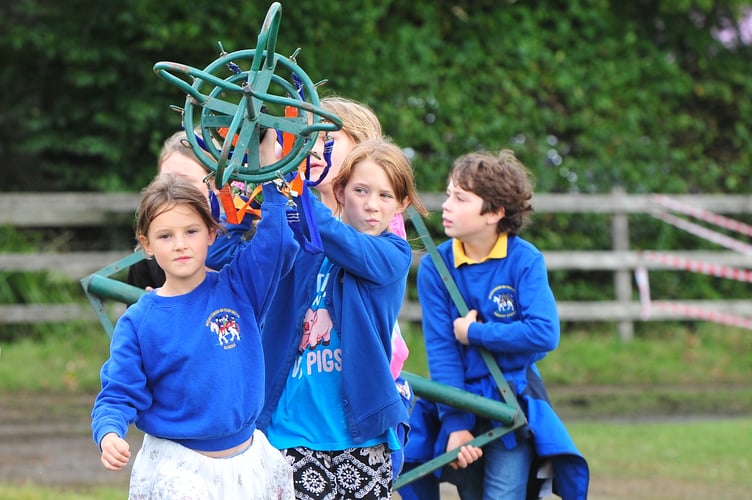 Widecombe Fair. Carrying in the pole for country dancing.  Pupils  from Widecombe Primary School get the day off to participate in and enjoy the fair.