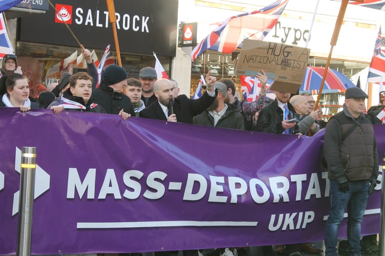 UKIP Leader Nick Tenconi holding the microphone as he leads anti-migrant chanting. AQ 0963

