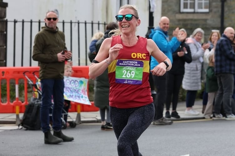 Joanne Page, of Okehampton Running Club, smiles as she finishes the Dartmoor Marathon in Tavistock as first woman .