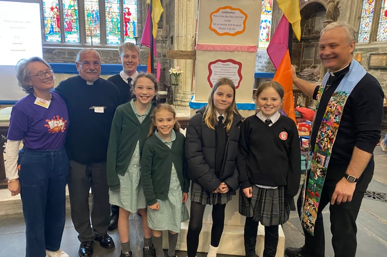 Youngsters celebrating Tavistock Parish Church Messy Church tenth anniversary with St. Eustachius’ Church vicar the Rev Matt Godfrey (right) and Sarah Pendle (far left) and the Rev Chris Hardwick.