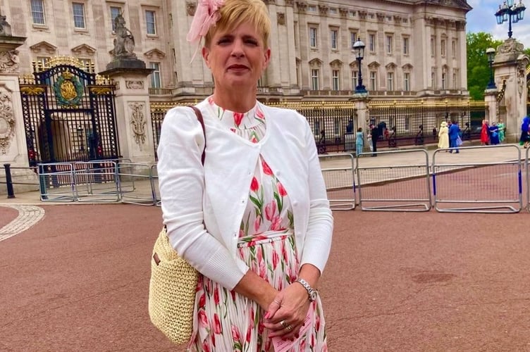 Deb Morris, manager of Tavistock Area Support Services (TASS), attended Buckingham Palace garden party with her husband Jim Morris (MBE) who snapped her outside the front of the palace.