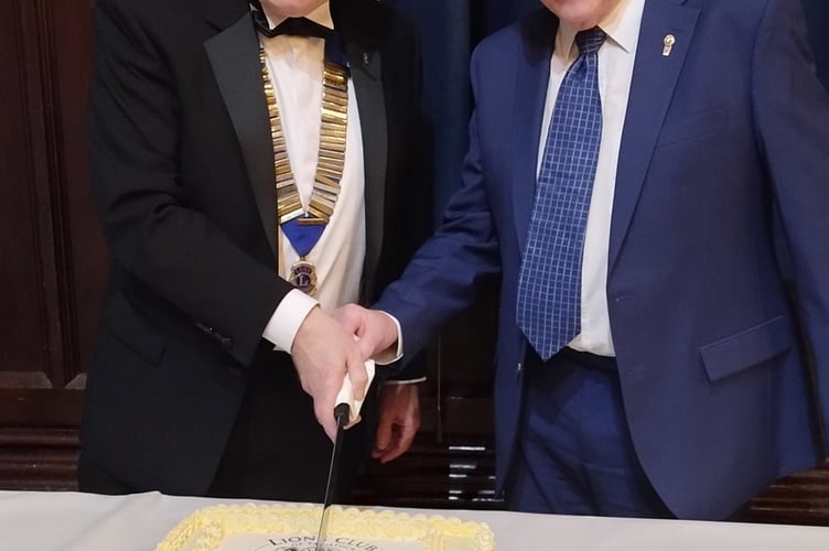 Cutting the Tavistock Lions' 50th birthday cake were current president Matt Hibbert and long-serving Lion David Inman.