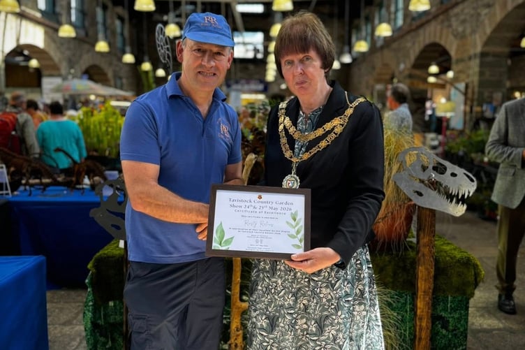 Master metal artist Philip King is presented with his Tavistock Country Garden Show certificate by newly-elected town Mayor Cllr Anne Johnson in the Pannier Market. Picture by Tavistock Town Council.
