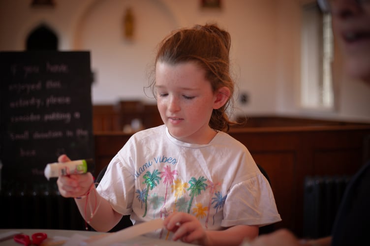 Kathryn, 8, enjoys making a paper Victorian style during a Tavistock Heritage Trust half-term session in the Guildhall. Picture by Sam Griffith.