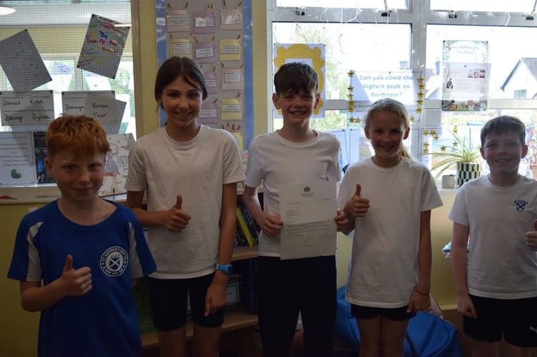 Delighted children of St Andrew's Academy in Buckland Monachorum with their replies to letters they wrote to the Prime Minister.