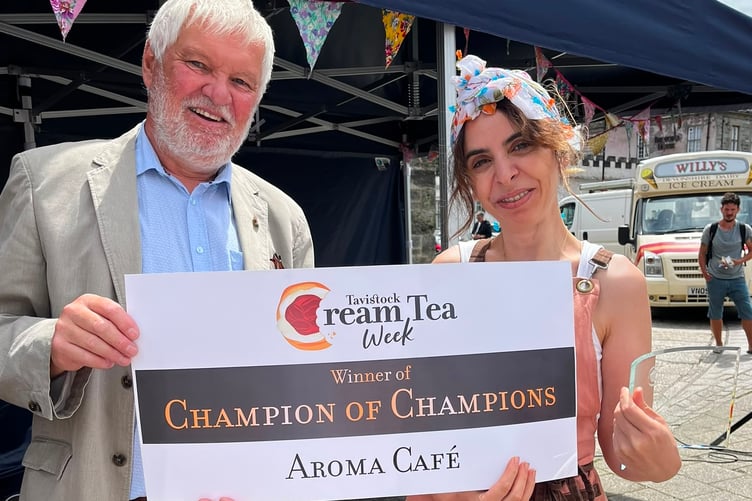 Ummi xxx, proprietor, of Aroma Cafe, presented with her champion of champions trophy for her entry into Tavistock Cream Tea Festival competition.