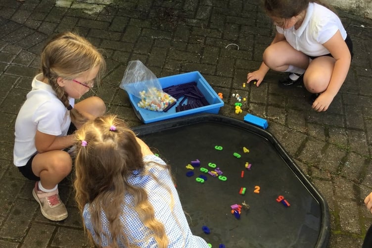 Bere Alston Primary School children enjoy adapted maths lessons in the outdoor shade during the heatwave.