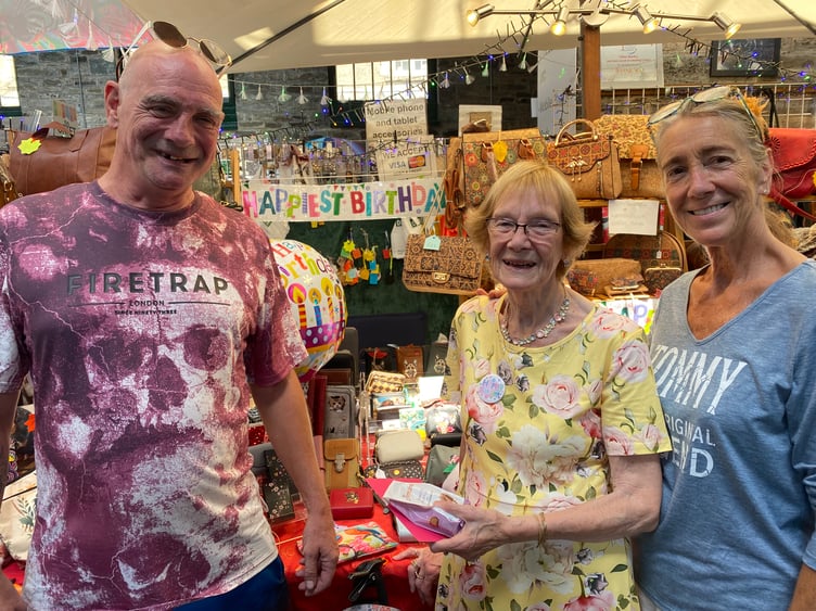 Lilian Hartley, her son Stephen and fellow trader Kay Gawman celebrate Lillian's eighty fifth birthday in Tavistock Pannier Market.