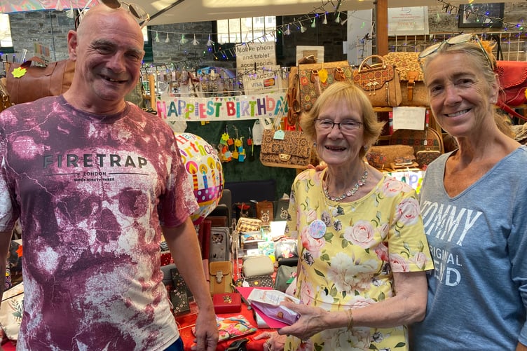 Lillian Hartley, her son Stephen and fellow trader Kay Gawman celebrate Lillian's eighty fifth birthday in Tavistock Pannier Market.