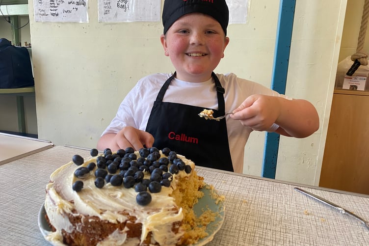 Callum is rightly proud of his blueberry cake which starred in Princetown School's bake-off competition.