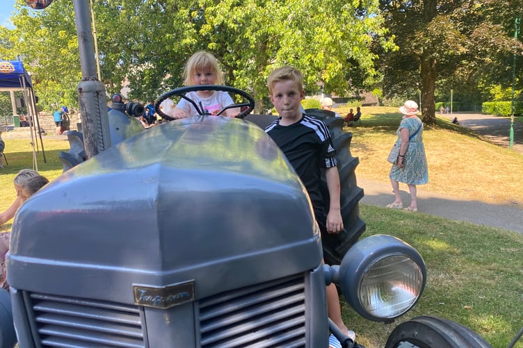 Youngsters in the driving seat of a vintage tractor at Tavistock Lions family fun day in the Meadows park.