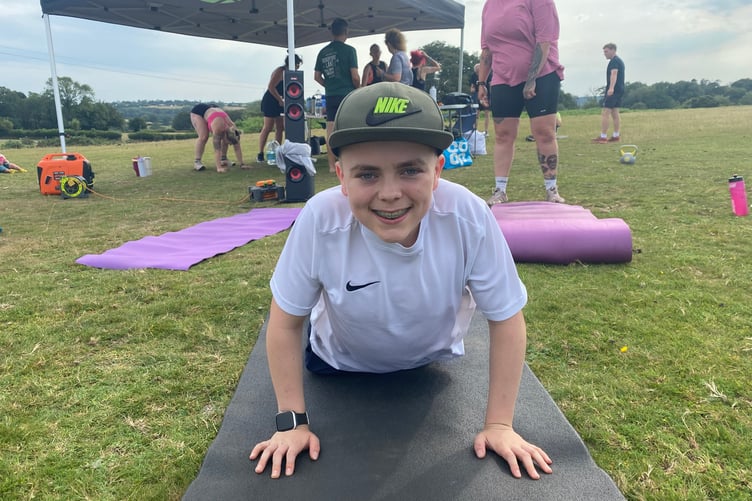 A youngster beats the heat by tackling the 1,000-repeats outdoor gym challenge in Whitchurch in aid of Tavistock Youth Cafe young people's group.