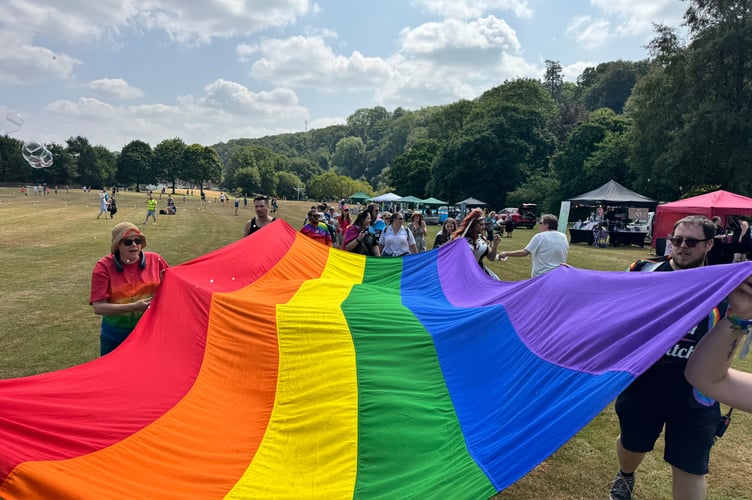 Carrying a giant rainbow flag at Okehampton Pride. AQ 5676