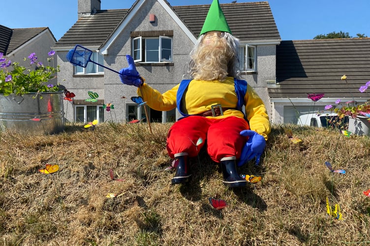 A fly-swatting gnome welcomes the judges from his garden wall during the judging for the Bere Alston In Bloom competition.