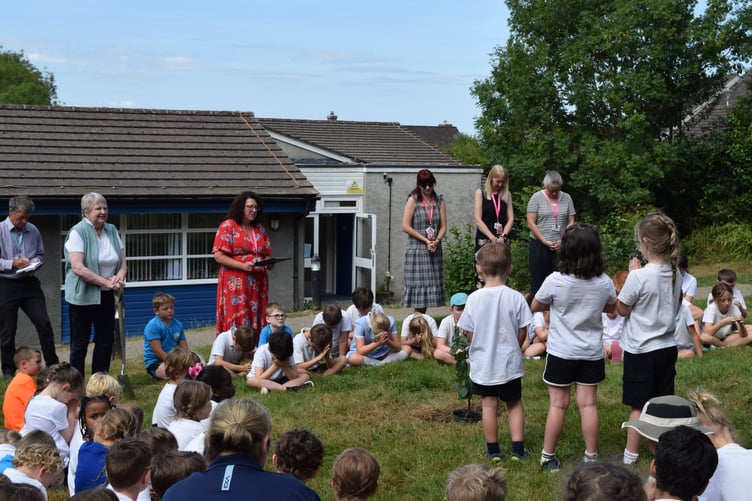 Headteacher Debbie Nunn makes a speech to pupils as Celia Steven, a relative of the man who bred the first Bramley apple, plants an apple tree at Bere Alston School with pupils helping.