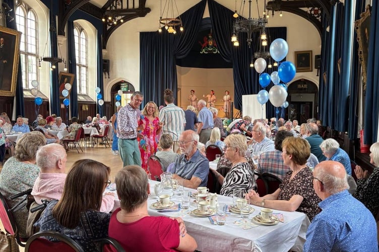 Tavistock Memory Cafe carers, family, volunteers and guest, celebrated its twentieth year by dancing, socialising and cutting a celebration cake in Tavistock Town Hall.
