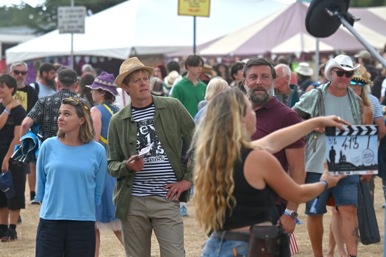 Beautiful Days music festival at Escot Park. Actors Sally Bretton and Kris Marshall filming an episode of Beyond Paradise at the event