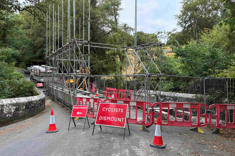 Special cantilevered scaffolding allowed work from a platform down in the gorge, to extract stone from the river and rebuild both parapets.