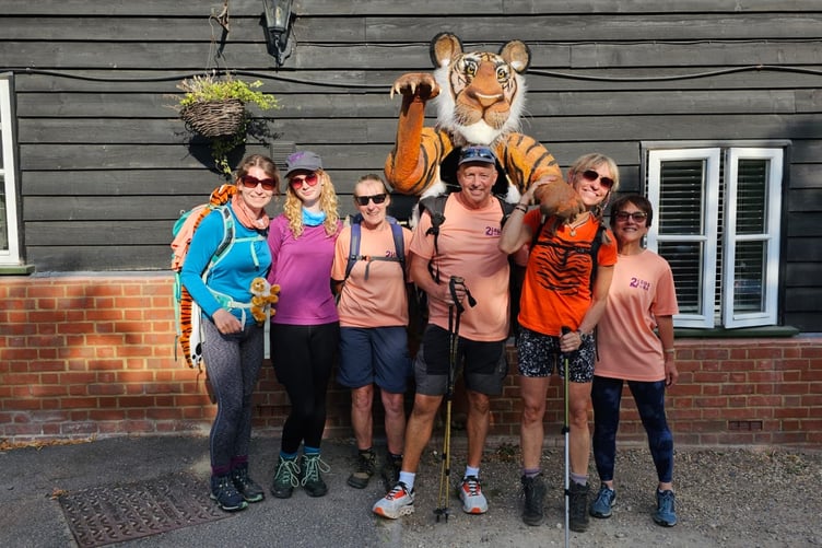 Paul Goldstein is stopping off in Tavistock on his 1,000-mile walk with a toy tiger strapped to his back in aid of tiger conservation. He is pictured with wildlife broadcaster Michael Strachan.